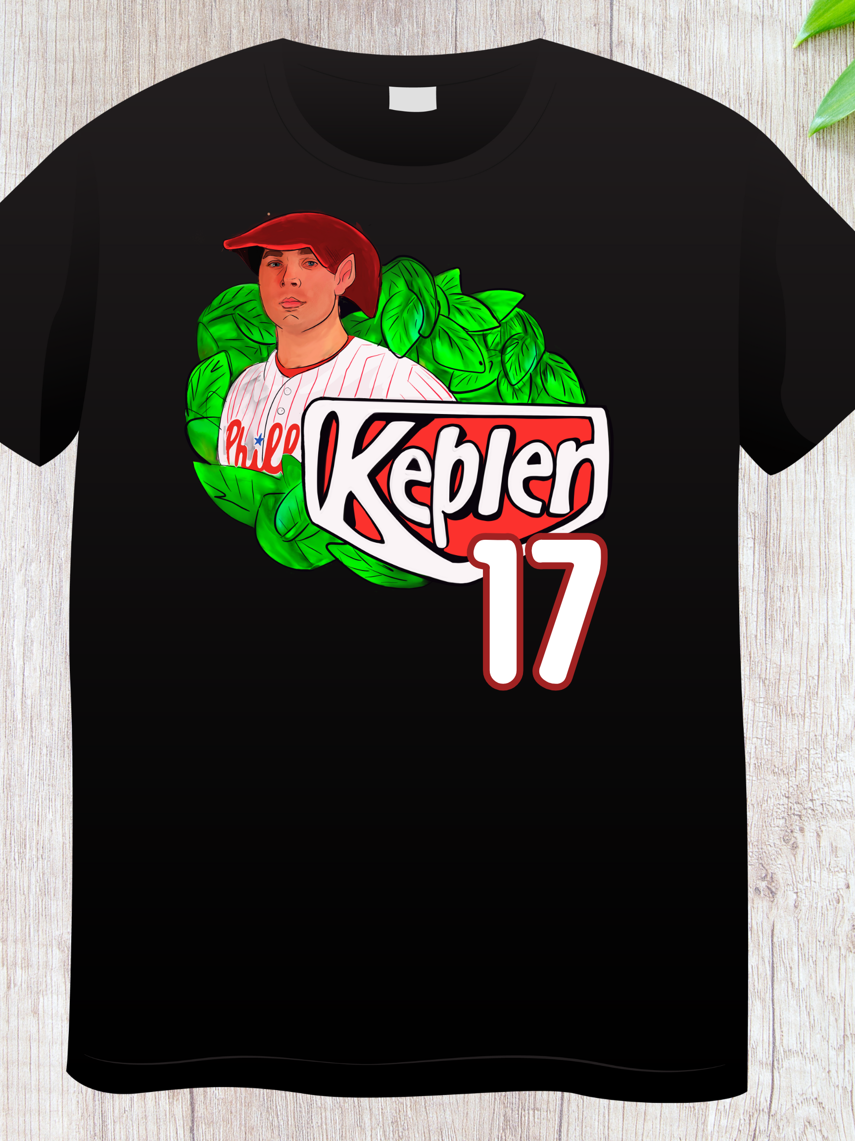 Woman wearing a black t-shirt with an elf-themed fantasy baseball parody graphic that reads "Kepler 17" with leafy background