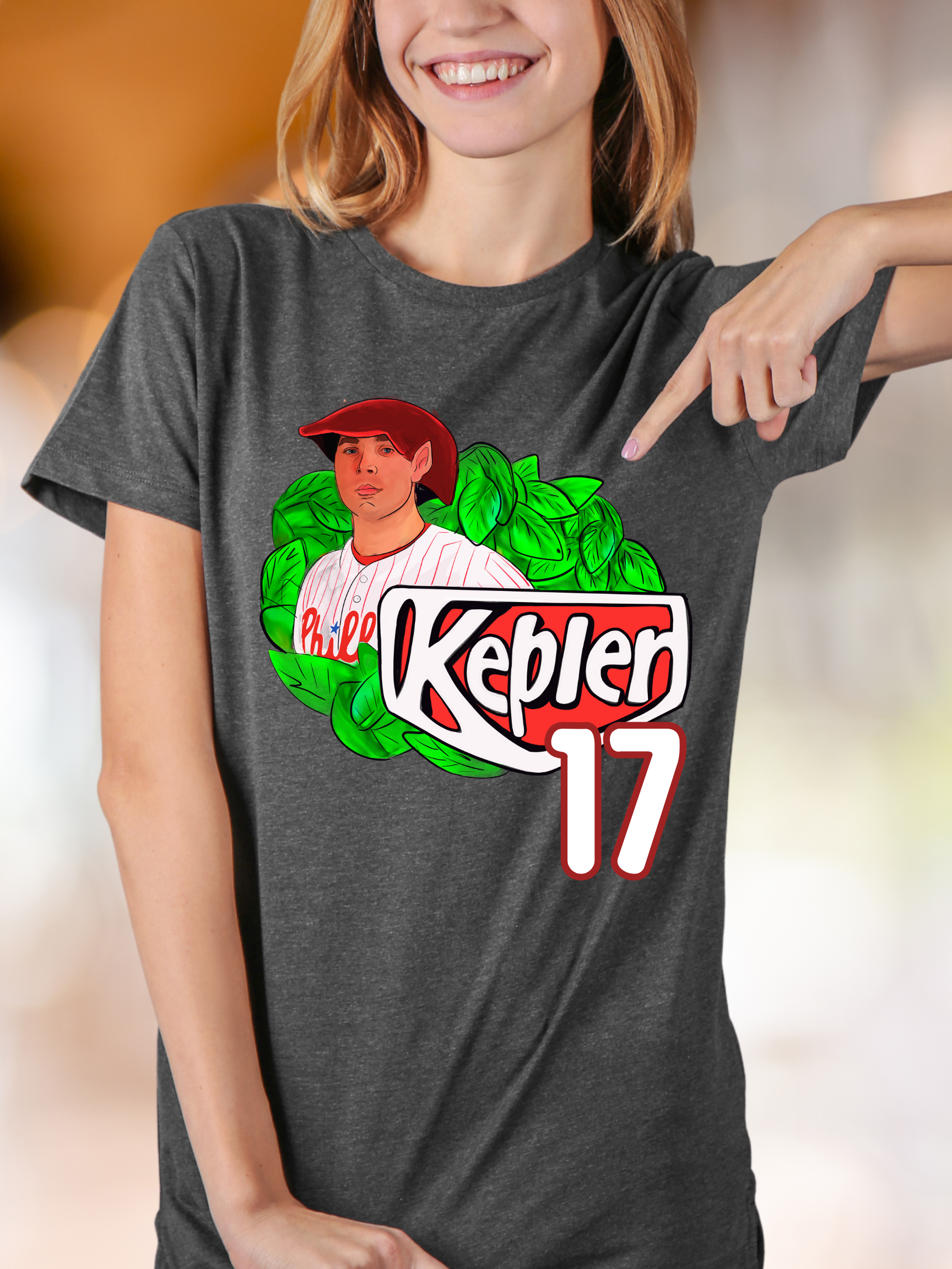 Woman wearing a greyk t-shirt with an elf-themed fantasy baseball parody graphic that reads "Kepler 17" with leafy background