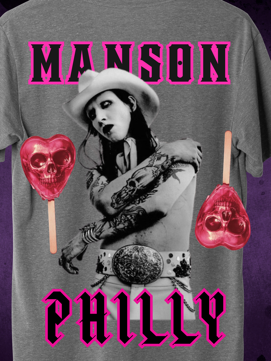 Grey t-shirt with a bold gothic western theme featuring a monochrome figure in a cowboy hat, pink skull lollipops, and the words "Manson Philly" in hot pink Old English-style font