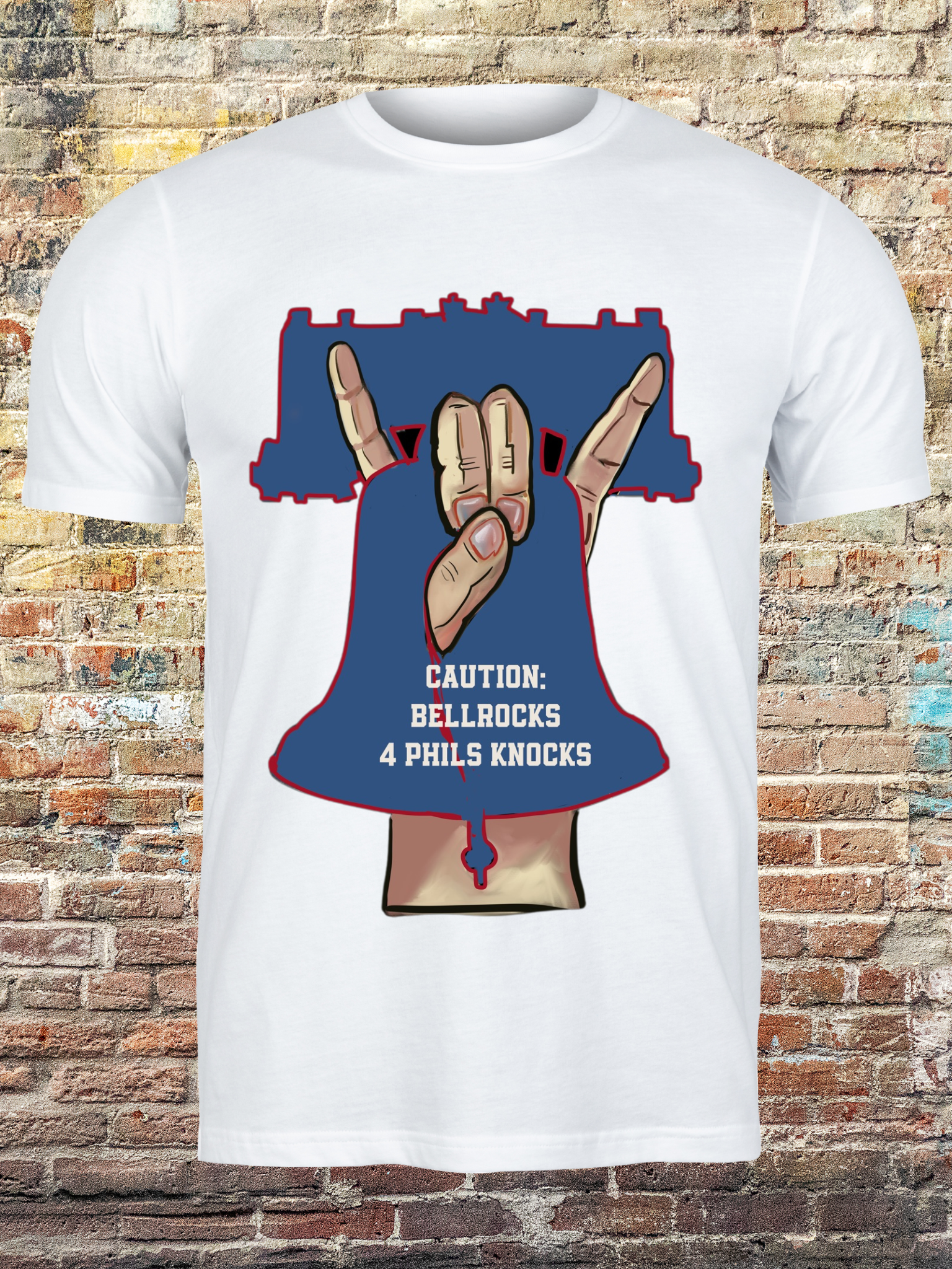 White t-shirt with a bold graphic of a hand gesture forming a bell shape inside a Liberty Bell outline, with text that reads “Caution: Bellrocks 4 Phils Knocks